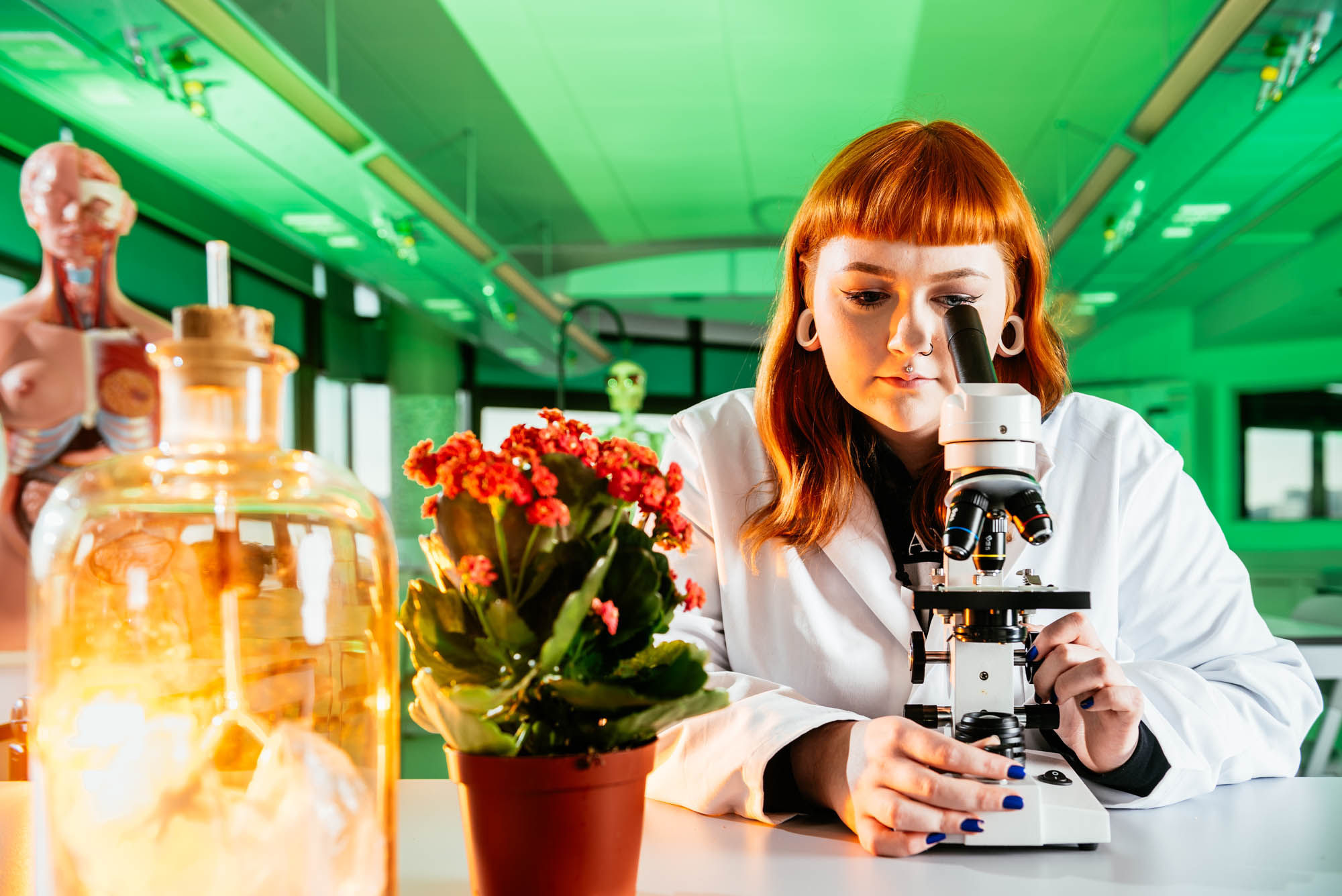 A science student looking into a microscope